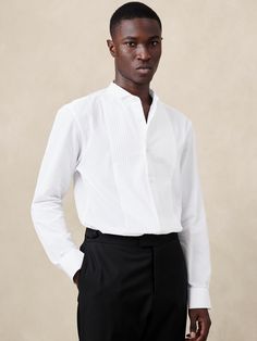 This tuxedo dress shirt is cut from a refined cotton fabric, selected for its incredible softness and light structure, accented with the traditional pleated tuxedo bib detail.  Standard fit.  Wing collar and button front.  Pleated bib detail.  Shirttail hem.  Standard fit.  Long sleeves.  Hip length.  Model: Size M, 6'2" (188cm). Light Structure, Tuxedo Shirt, Wing Collar, Tuxedo Dress, Tuxedo Shirts, International Fashion, Formal Shirts, Mens Shirt Dress, Hip Length