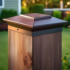 a wooden post with a metal cap on it