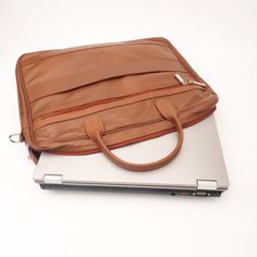 Made for men and women, our Executive Leather Laptop Bag is all about upgrading your work look .High Quality Bags with maximum functionality and minimal design to carry your laptop, files ,documents in a minimal possible way.Features ﻿ Crafted with 100% genuine Cow leather Laptop Compartment Size: Upto 15.5 inch Removable, adjustable padded shoulder strap Rear smart zipper allows you to attach this bag to the extended handles of rolling cases Main compartment has two large sections with one pock Professional Leather Laptop Bag For Everyday Use, Professional Satchel With Leather Lining, Professional Laptop Bag With Leather Lining For Everyday Use, Classic Leather Laptop Bag With Sleeve, Professional Bags With Leather Lining For Everyday Use, Professional Leather Briefcase For Daily Use, Professional Briefcase With Leather Lining For Everyday Use, Professional Leather Briefcase With Laptop Sleeve, Professional Brown Laptop Bag For Everyday Use