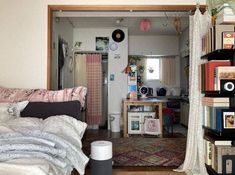 an open door leading to a bedroom with a bed and bookshelf in it