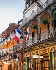 an old building with flags hanging from the balconies