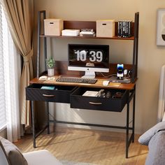 a desk with a computer on it in front of a window