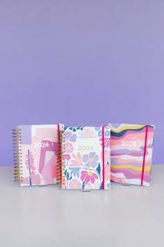 three notebooks lined up next to each other