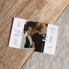 a couple kissing each other in front of a calendar