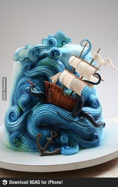 a cake that looks like an ocean wave with a ship on top