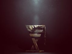 a chair sitting on top of a wooden table under a sky filled with stars and light