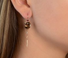 These Drop Earrings are elegant, long, boho style. They attach to 14K Rose gold ear wires and would upgrade any outfit. ► 14K Rose Gold► Total Weight: 5 gr► Oval Smoky Topaz: 10x12 mm ► Garnet stones: 3 mm each► 14K Rose gold latching ear wires► 11x27 mmAll items are Handmade, I pay a lot of attention for every detail in the jewelry I design.All of my items are hand crafted in Kisufim's Designer jewelry Store in Tel Aviv, and shipped direct to customers all over the world. I am proud to say that Elegant Latkans Earrings For Formal Occasions, Elegant Evening Jewelry With Latkans, Elegant Brown Dangle Earrings, Elegant Latkans Earrings As Gift, Elegant Latkans Earrings For Gifts, Elegant Brown Evening Jewelry, Elegant Brown Jewelry, Elegant Teardrop Jewelry With Latkans, Elegant Oval Brown Earrings