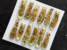 several slices of zucchini sitting on top of a white plate with toppings