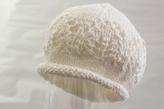 Pattern Written In ENGLISHA classic and simple hat that you can knit for a newborn.Choose cotton/silk blend for a really soft finish,perfect for newborn skin.This hat is knit in the round and features a rolled edge and lovely lace panel.All you need is 25 g of cotton/silk blend yarn and a set of DPN's in 3.25 mm or US 3.A perfect project for someone who is new to lace knitting.Size: Newborn about 33 cm or 13 inches hat circumferencePattern is copyrighted and intended for personal use only.Buy 3 White Knitted Hat, One Size Fits Most, White Knitted Hat One Size Fits Most, White Knitted Cap Hat, White Knitted Cap, White Knitted Short Brim Hat, White Hand Knitted Brimmed Hat, White Hand-knitted Brimmed Hat, White Knitted Hat With Curved Brim, Hand Knitted White Hat Gift