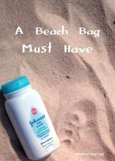 a bottle of sunscreen sitting on top of a sandy beach next to the words, a beach bag must have