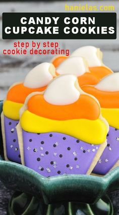 some cupcakes with icing on them in a green bowl and text overlay that reads candy corn cupcake cookies step by step by step decorating