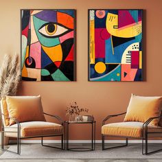 two abstract paintings hang on the wall in a living room with chairs and a coffee table