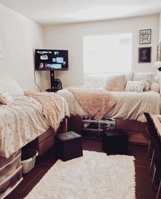 a bedroom with two beds and a tv