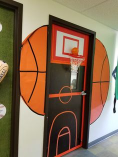 an indoor basketball court is painted on the wall next to a door with shoes hanging from it