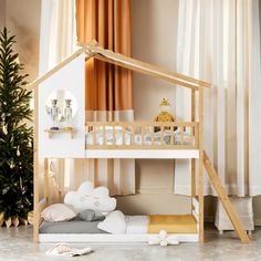 a white bunk bed with a wooden frame and stairs in front of a christmas tree