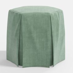 a small stool with a green cover on it