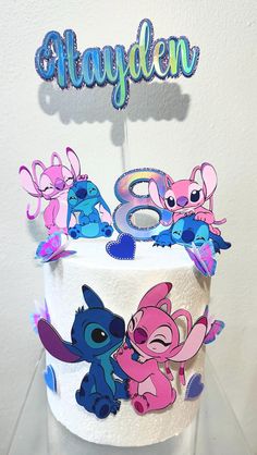 a birthday cake decorated with cartoon characters and the number eight on it's top