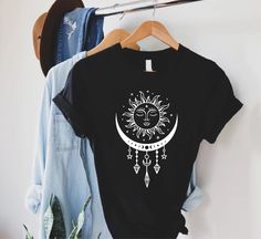 Celestial Sun and Moon Shirt, Mystical Sun T-shirt, Boho Summer Shirt, Yoga Outfit, Bohemian Gift Shirt, Spiritual Shirt, Astrology Lover Gift  HOW TO ORDER 1-) Please, check and review all the photos. 2-) Choose your t-shirt size and color. *Different styles of shirts may have different shades of the same color choice due to different manufacturer brands. *For this reason, we recommend matching shirts from the same styles if you want precisely matching colors (ex. Unisex, V-necks, Toddler, etc. Sun And Moon Shirt, Celestial Sun And Moon, Moon Phases Shirt, Spiritual Shirts, Celestial Sun, Yoga Outfit, Moon Shirt, Matching Colors, Shirt Fits