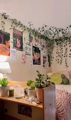 a bedroom with plants and posters on the wall