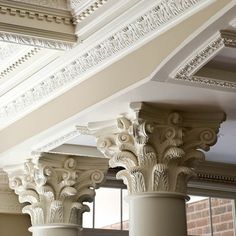 two white pillars with decorative designs on them