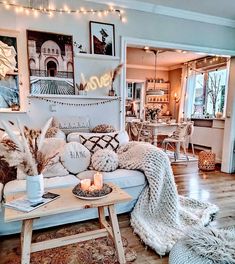 a living room filled with lots of furniture and decor on top of a hard wood floor