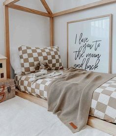 a bed room with a neatly made bed and checkered blanket on the coverlet