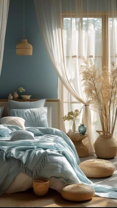 a bedroom with blue walls and white curtains