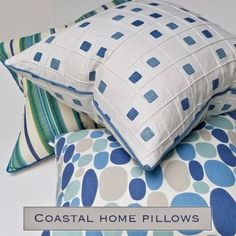 three pillows stacked on top of each other with the words coastal home pillows above them