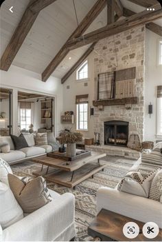 a living room filled with lots of furniture and a fire place in the middle of it