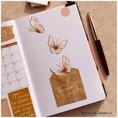 an open planner with butterflies on it