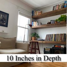 a living room filled with furniture and bookshelves on top of wooden flooring