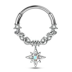 a silver ring with an opal star charm on the end and crystal stones around it