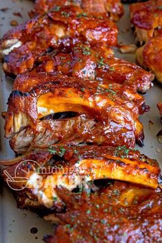 ribs covered in bbq sauce and garnished with green sprinkles