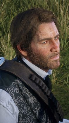 a close up of a person wearing a suit and tie with grass in the background