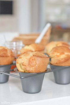 some muffins are sitting in cups on a table