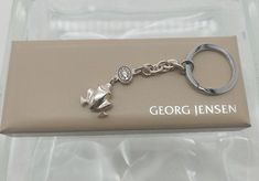 a close up of a key chain on a box