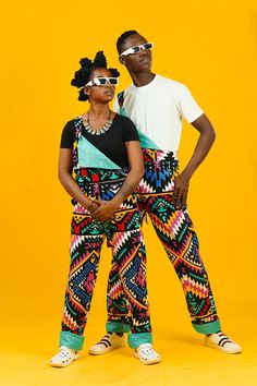 Aztec Overalls, African Dungarees, Festival Dungarees Stand out from the crowd in these unique African overalls. They have a striking abstract aztec print and these ankara dungarees are all you need to add a slice of sunshine to every day. All of our festival dungarees are unisex and feature loads of pockets and a cool turn-up leg that can be adjusted to your size. What's not to love? Grab yourself a pair and dance your way through life!  - Fun and funky dungarees - Lined in blue cotton fabric - Multicolor Cotton Sets With Traditional Patterns, Festival Multicolor Sets With Traditional Patterns, Multicolor Festival Sets With Traditional Patterns, Multicolor Cotton Overalls With Patchwork, Multicolor Festival Overalls, Ankara Dungaree, Ankara Dungarees, Multicolor Patchwork Overalls, Orange Dungarees