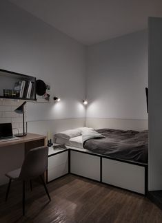 a bedroom with a bed and desk in it