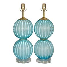 two blue glass lamps sitting on top of each other