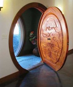 an oval mirror with writing on it in the middle of a room next to a window