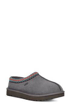 A warm, suede slipper with embroidered trim and a plush genuine-shearling lining can be worn in or out of the house thanks to the grippy sole. Style Name:UGG Tasman Slipper (Women). Style Number: 30154.