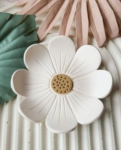 a white flower shaped object sitting on top of a table