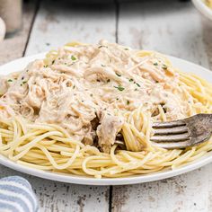 a white plate topped with pasta covered in gravy