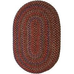 the oval rug is red and brown with multicolored braiding on it's sides