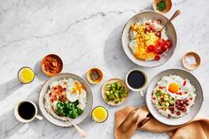 three bowls filled with different types of food on top of a white countertop next to sauces and seasonings