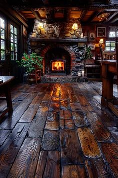 a room with wood floors and a fireplace in the center that is lit by lights