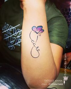 a woman's arm with a tattoo on it that has a flower in the shape of a heart