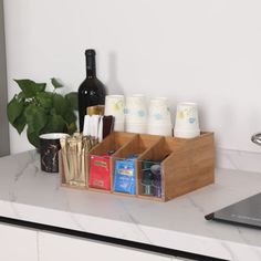 a kitchen counter with an open wooden box on it and various items in the drawer