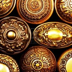 many gold buttons with ornate designs on them