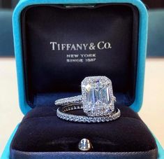 an engagement ring in a blue box with the name tiffany & co written on it